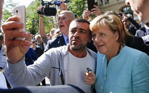 'Selfie' photo of German Chancellor Angela Merkel and migrant